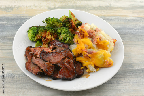 BBQ beef brisket with broccoli and mashed potatoes with cheese and bacon