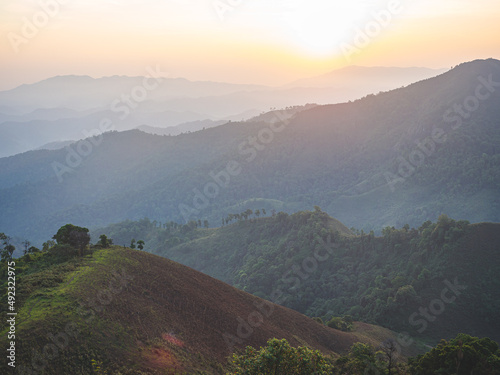 Beautiful nature of sunrise and mountains complex with morning mist atmosphere at Tak  Thailand.