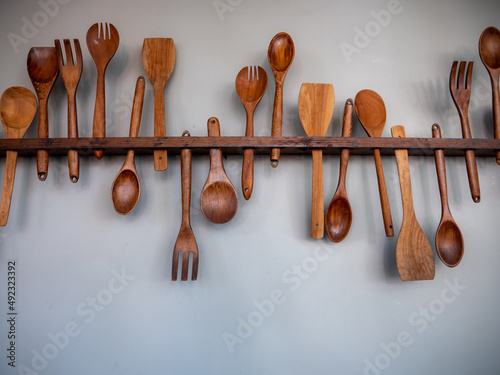 Wooden Spoon Fork and Ldle Hanging on The Wooden Rail
