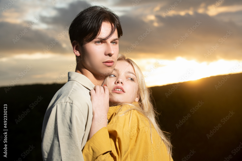 Portrait of lovely couple in love. Young sensual girlfriend glad to passionate kiss from her boyfriend. Handsome young man embraces his woman and kisses. Portrait of lovely couple in love. Young sensual girlfriend glad to passionate kiss from her boyfriend. Handsome young man embraces his woman and kisses.