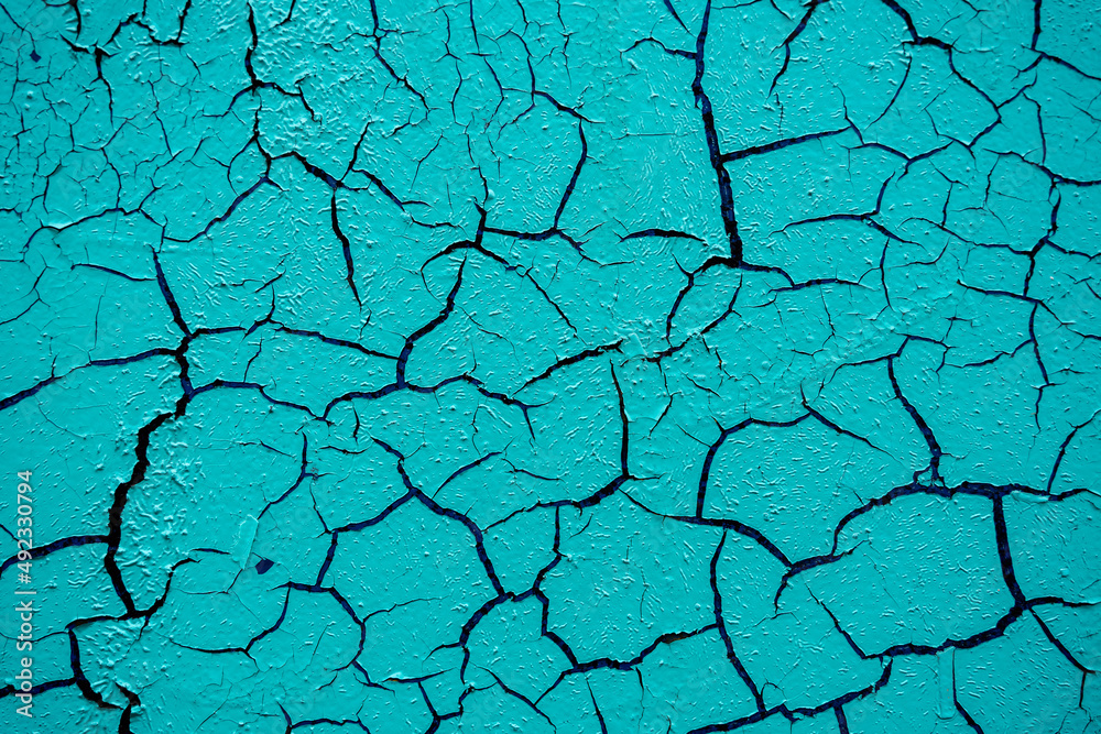 Cracked and damaged painted surface of a building or wall. Texture, aged paint background Cracked and damaged painted surface of a building or wall. Texture, aged paint background