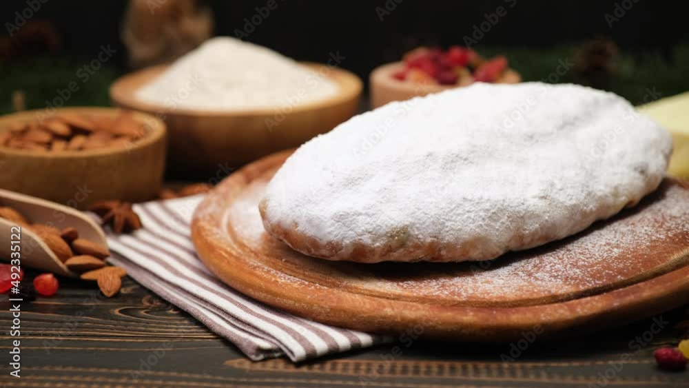 Traditional Christmas stollen cake recipe with ingredients on wooden background Traditional Christmas stollen cake recipe with ingredients on wooden background
