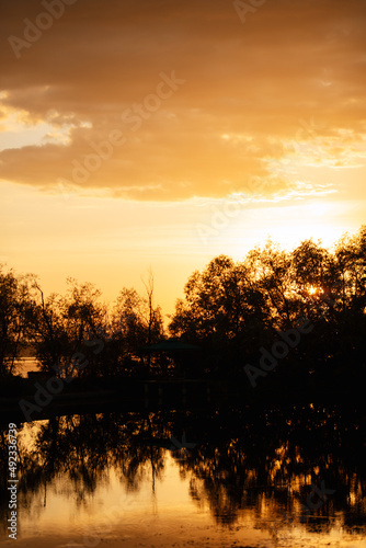 orange sunset on the river with silhouettes