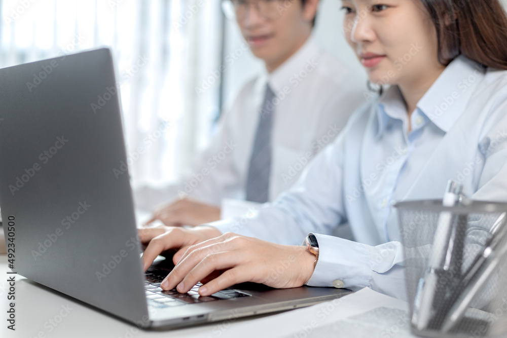 Businesswoman's hand presses on a laptop keyboard, World of technology and internet communication, Using computers to conduct financial transactions because the convenience and speed. Businesswoman's hand presses on a laptop keyboard, World of technology and internet communication, Using computers to conduct financial transactions because the convenience and speed.