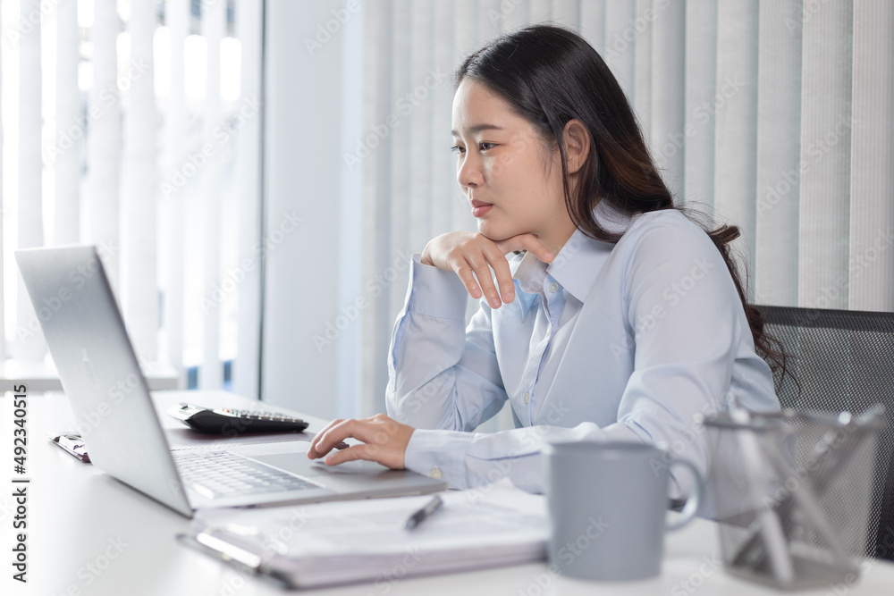 Businesswoman using laptop for financial and accounting work, Using computers to conduct financial transactions because the convenience, Freelancers work, Online communication, Internet, Wireless. Businesswoman using laptop for financial and accounting work, Using computers to conduct financial transactions because the convenience, Freelancers work, Online communication, Internet, Wireless.
