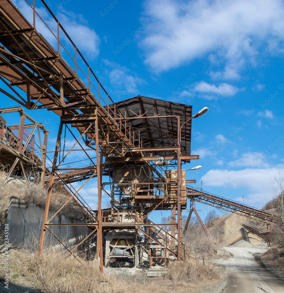 An old gravel quarry. Mining and quarrying equipment. Granite gravel stone open pit mining.