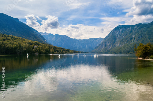 Lake Bohinj in Slovenia. Beautiful nature, big lake and high mountains around. Summer weather for swimming and recreation by the water.