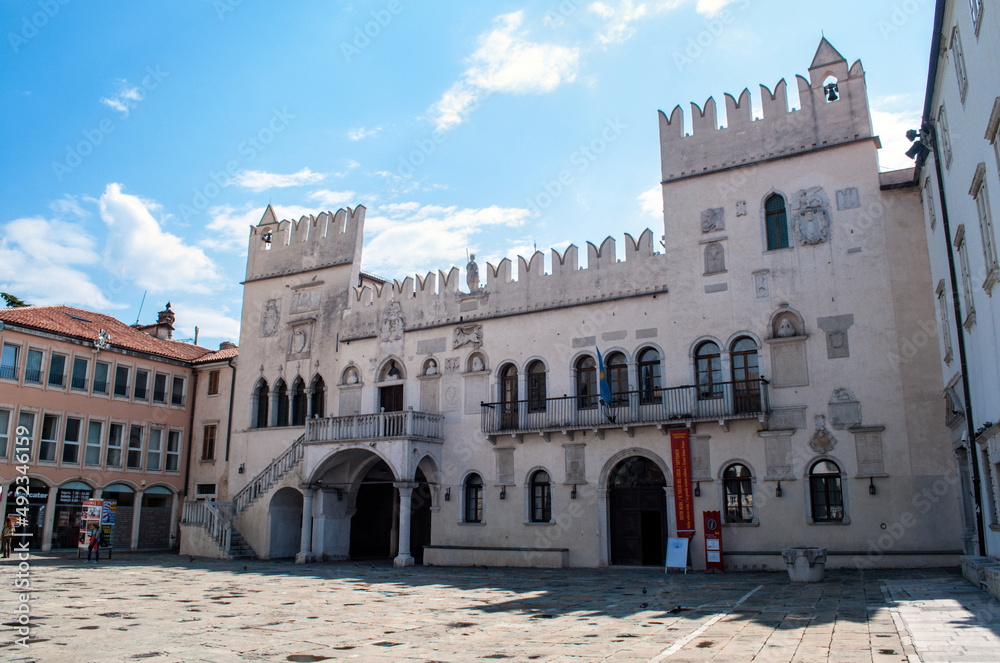 Old house with battlements and two towers on the main square of the port city of Koper in Slovenia.