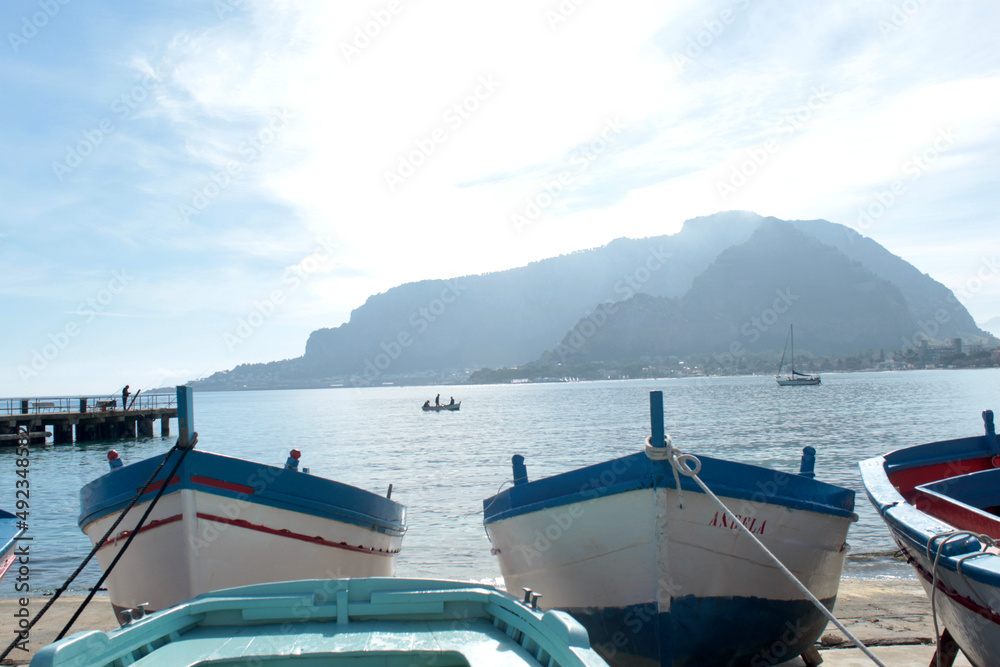 Sea coast with fishermen's boats with view from Palermo Italy in sunset