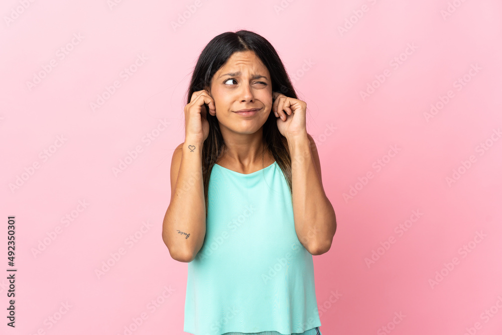 Caucasian girl isolated on pink background frustrated and covering ears Caucasian girl isolated on pink background frustrated and covering ears