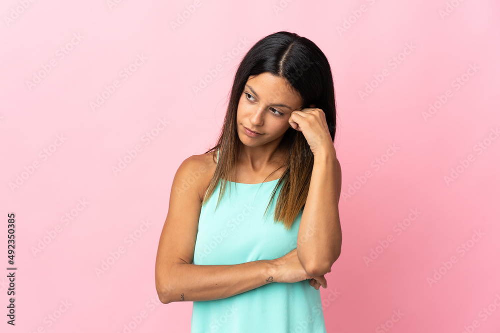 Caucasian girl isolated on pink background with tired and bored expression