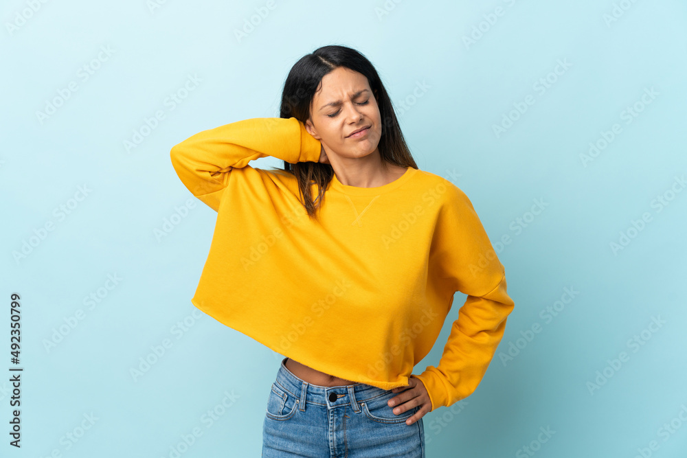Caucasian girl isolated on blue background with neckache Caucasian girl isolated on blue background with neckache