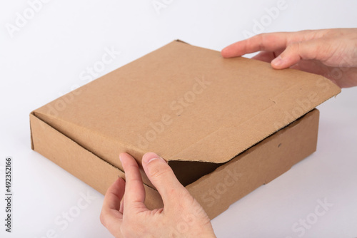 A woman installing a pizza box on a white background