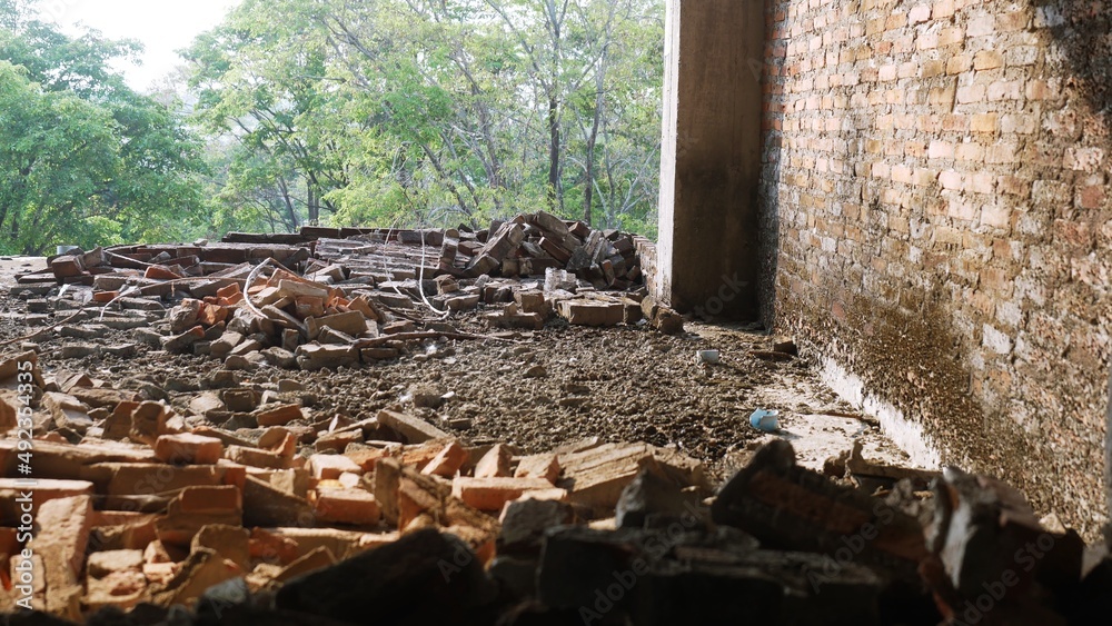 Close-up of the rubble of an industrial building collapsing into a pile of concrete and brick. and the jagged debris caused by the failure of the engineers at the abandoned construction. Close-up of the rubble of an industrial building collapsing into a pile of concrete and brick. and the jagged debris caused by the failure of the engineers at the abandoned construction.