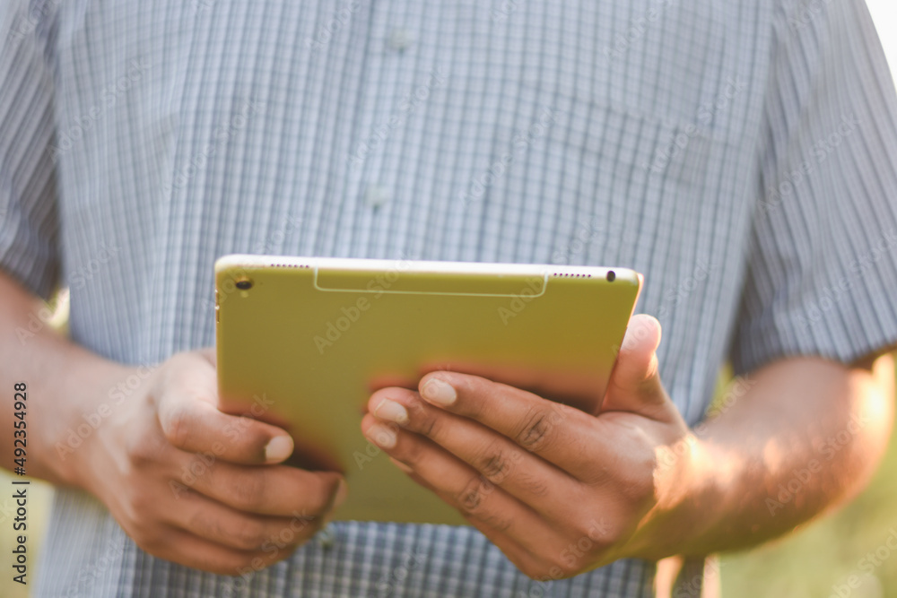 Businessman's hand using a tablet to check information Businessman's hand using a tablet to check information