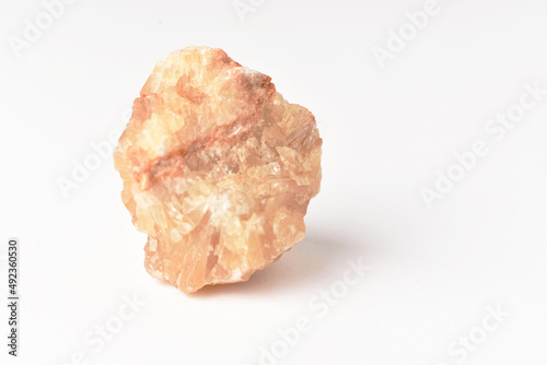 One  uncut and rough Sunstone crystal,quartz on white