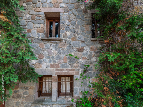 Wood and glass windows on the stone wall of an old house. Pachia Rachi, Aegina, Greece. photo