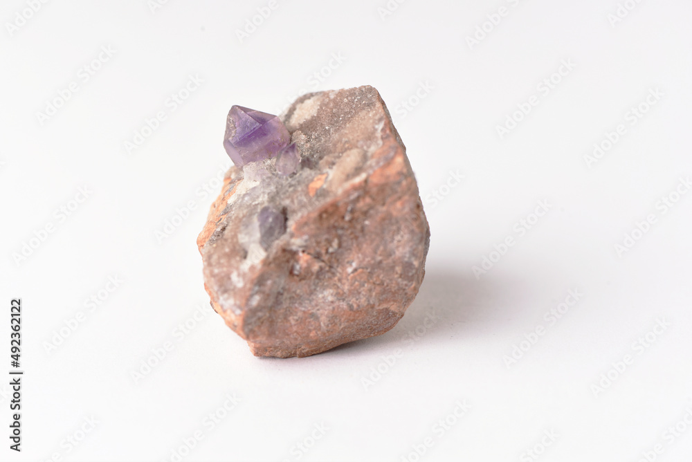amethyst crystal grown on another stone ,marble, granite,
