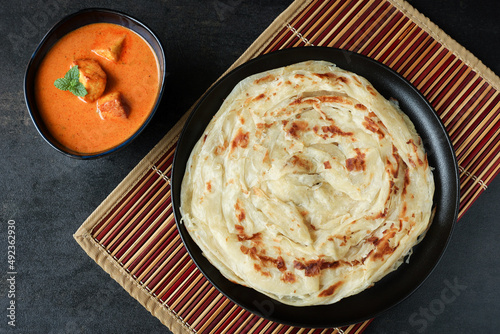 Kerala parathas / porotta / roti / parotta / barotta/ naan layered flatbread made from maida or whole wheat flour. Eat with spicy Asian chicken or beef or egg curry gravy. breakfast dish. Indian food. photo