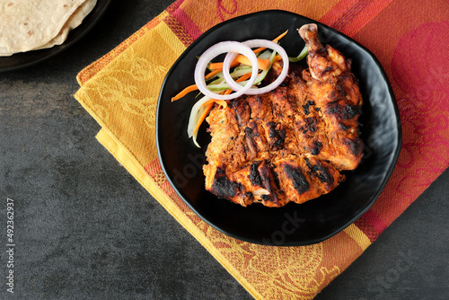Arabian grilled chicken also called Al Faham or Alfaham or Djaj very popular recipe in Middle East. made using mix Bezar spices and barbeque in a charcoal grill or in oven. photo