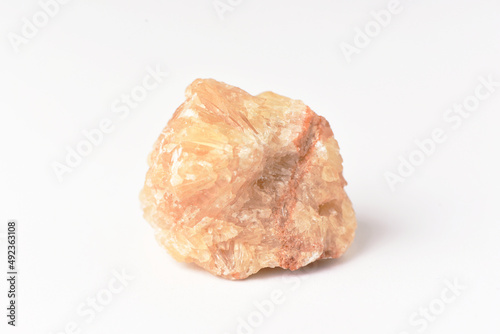 One  uncut and rough Sunstone crystal,quartz on white
