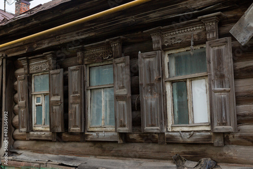 The beautiful old windows with beautifully designed platbands window on an old wooden house in the city of Tula