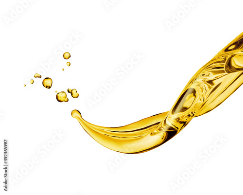 From a flying gush of golden yellow oil, individual drops of oil are thrown into the air against a white background.