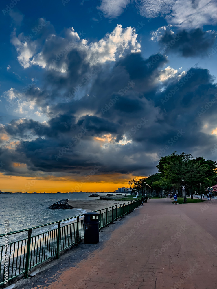 Sunset with a passing dark cloud by the restaurants in East Coast Park