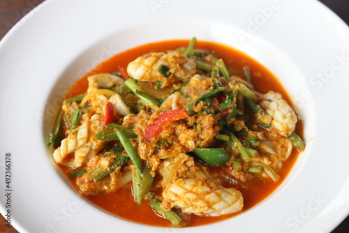 Popular Thai seafood dishes, Stir-fried squid with curry powder in white plate.