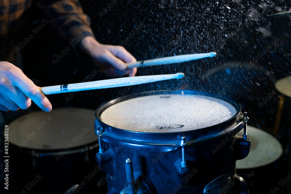 close up hand of man musician playing on drums in music studio close up hand of man musician playing on drums in music studio
