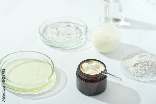 petri dishes with medium and glassware on a laboratory table. fermentation, fermented beauty skin care. container with cream or solution or serum for anti age treatment developed in a lab