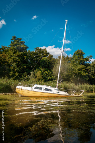Half sunken sports yacht at the coast