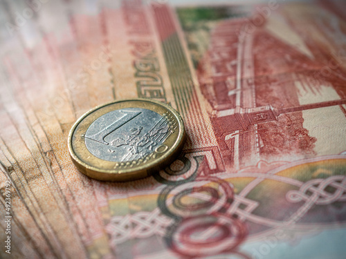 Euro and rouble. Foreign currency exchange. Russia and EU. Economic crisis. Russian money. Investment, business and finance. Emerging markets. Money background. Money in cash. Euro coin on roubles
