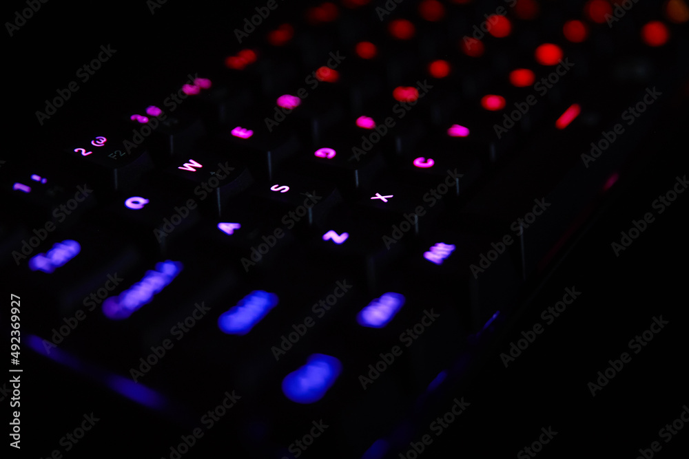 Gaming keyboard, close up. Mechanical rgb keyboard for computer games on dark backgound Gaming keyboard, close up. Mechanical rgb keyboard for computer games on dark backgound