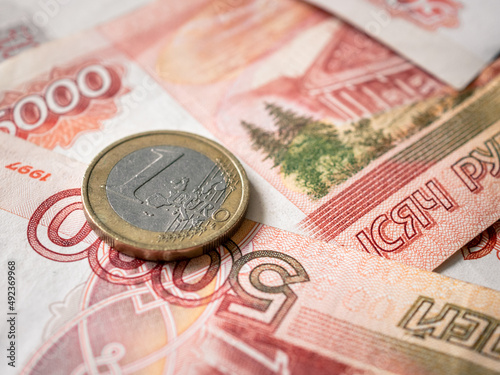 Euro and rouble. Foreign currency exchange. Russia and EU. Economic crisis. Russian money. Investment, business and finance. Emerging markets. Money background. Money in cash. Euro coin on roubles