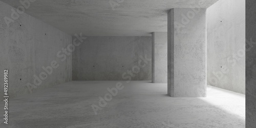 Abstract empty, modern concrete walls room with top light from right behind wide cement pillars - industrial interior background template