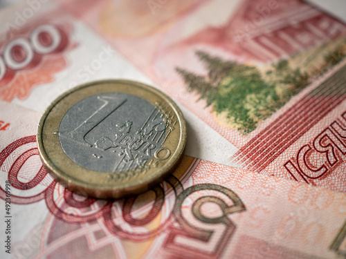 Euro and rouble. Foreign currency exchange. Russia and EU. Economic crisis. Russian money. Investment, business and finance. Emerging markets. Money background. Money in cash. Euro coin on roubles