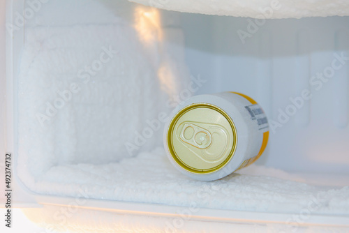 cans of beer were immersed in the freezer of the refrigerator,