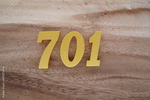 Photos Golden Arabic numerals on a real brown and white wooden floor number 701