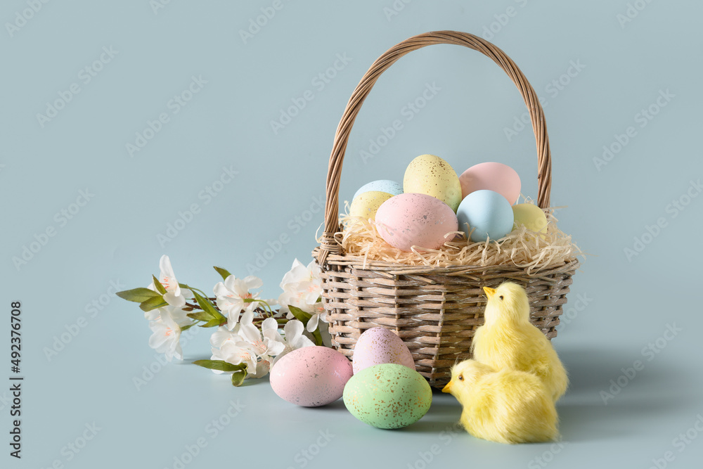 Easter wicker basket with pastel eggs for Happy holiday and celebration on blue background. Spring greeting card. Easter wicker basket with pastel eggs for Happy holiday and celebration on blue background. Spring greeting card.