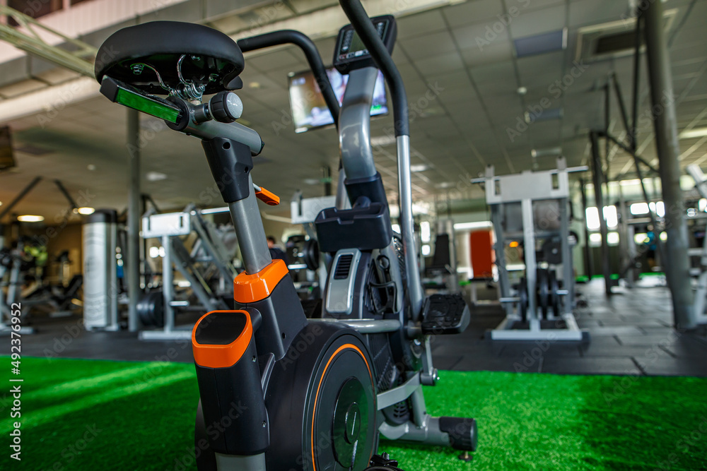 Modern gym interior with equipment. Fitness club with a range of exercise bikes. Healthy lifestyle concept Modern gym interior with equipment. Fitness club with a range of exercise bikes. Healthy lifestyle concept