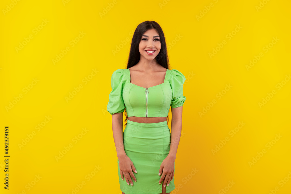 Obraz premium Portrait of happy young woman posing at studio