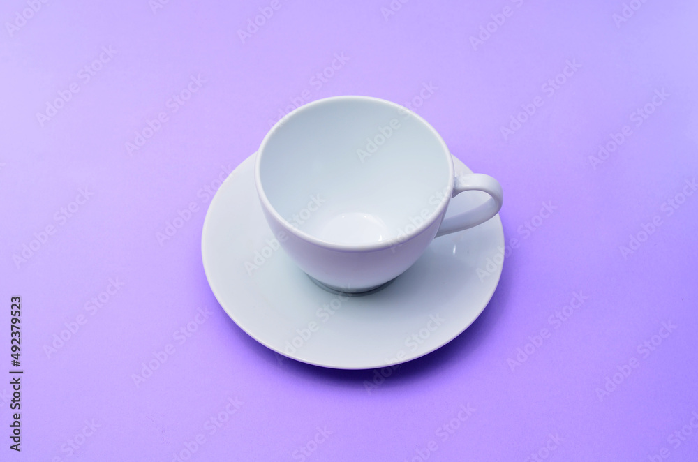 White empty coffee cup on a purple background. White empty coffee cup on a purple background.