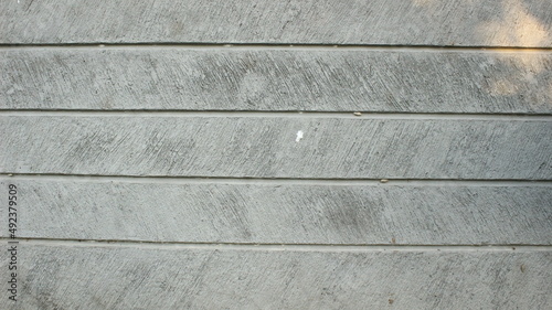 background of a cement wall that has a pattern of parallel lines