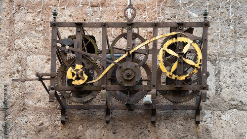 Old clock mechanism on the wall 