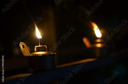 Traditional kerosene lamp light  also known as pelita isolated in a dark background. photo