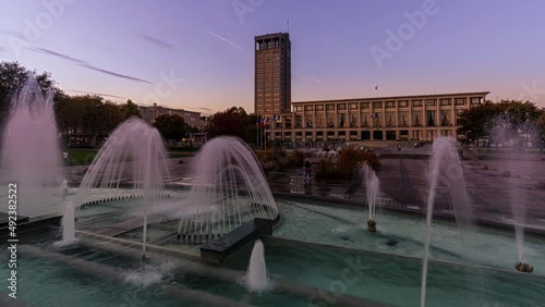 Day to Night Timelapse of the City Hall in Le Havre, France and the fountains on  the Square 
