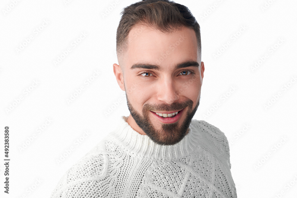 Fototapeta premium Male model shot in studio. Casual style and look with a modern and fresh approachable expression. Happy and smiling. Headshot of man with a beard, brown hair, brown eyes on a white solid background. 