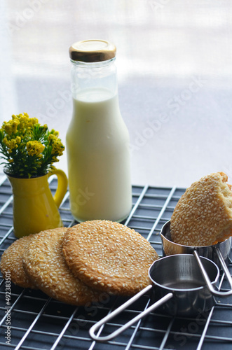 A bottle of milk and low calories sesame biscuits : healthy lifestyle concept (selective focus image)