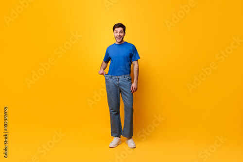 Happy Man Pulling His Old Large Loose Jeans